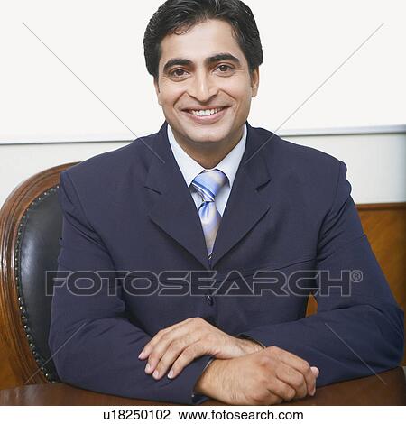 Portrait of a businessman sitting in a conference room View Large Photo Image Stock Image - Portrait of a businessman sitting in a conference room. Fotosearch