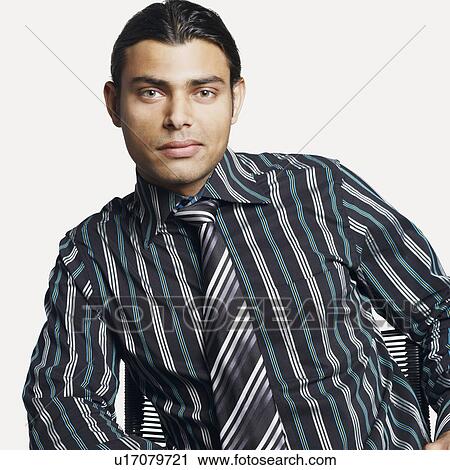 Stock Image - Portrait of a businessman sitting on a chair. Fotosearch
