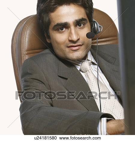 Portrait of a businessman wearing a headset View Large Photo Image Stock Image - Portrait of a businessman wearing a headset. Fotosearch