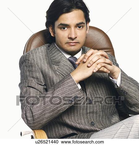 Stock Image - Portrait of a businessman with his hands clasped. Fotosearch