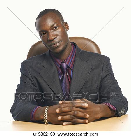 Stock Photo - Portrait of a businessman with his hands clasped. Fotosearch