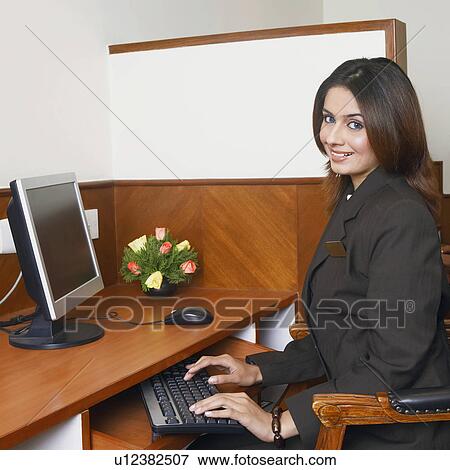 Stock Photo - Portrait of a businesswoman working on a computer. Fotosearch