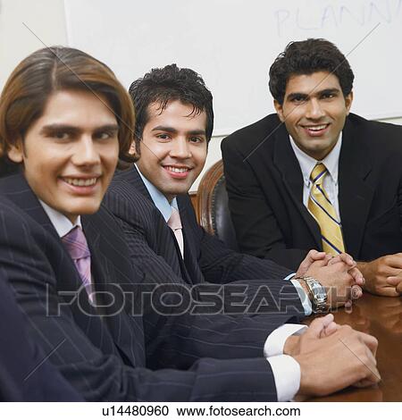 Stock Image - Portrait of three businessmen smiling. Fotosearch