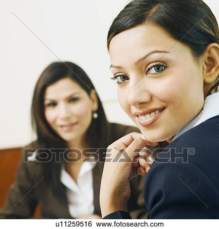 Portrait of two businesswomen smiling View Large Photo Image Stock Photograph - Portrait of two businesswomen smiling. Fotosearch