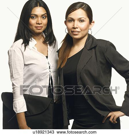 Stock Image - Portrait of two businesswomen standing together. Fotosearch