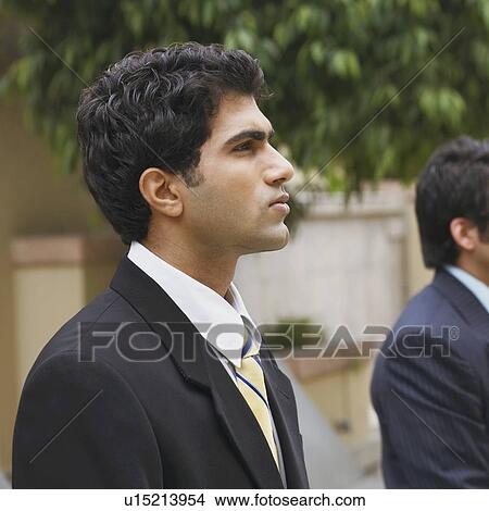 Picture - Side profile of a businessman looking serious. Fotosearch