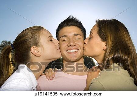 Two Teenage Girls Kissing A Boy Stock Photography U Fotosearch
