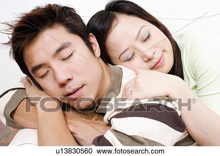 Close-up of a mid adult man and a young woman sleeping on a couch View Large Photo Image Stock Image - Close-up of a mid adult man and a young woman sleeping on a couch. Fotosearch