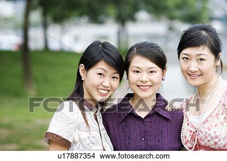 Close-up of three young women smiling View Large Photo Image Picture - Close-up of three young women smiling. Fotosearch