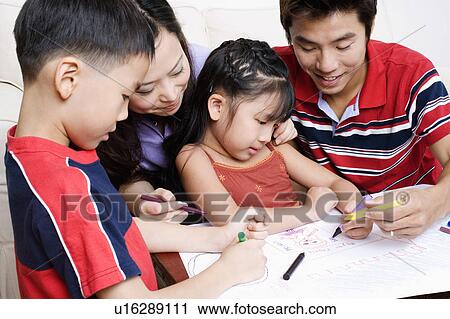 Close-up of two children drawing on paper with their parents View Large Photo Image Stock Image - Close-up of two children drawing on paper with their parents. Fotosearch