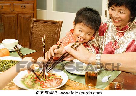 Mature woman and her grandson eating with chopsticks View Large Photo Image Stock Image - Mature woman and her grandson eating with chopsticks. Fotosearch