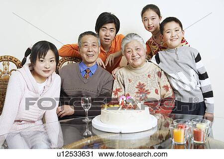 Stock Image - Portrait of a family at a birthday party. Fotosearch