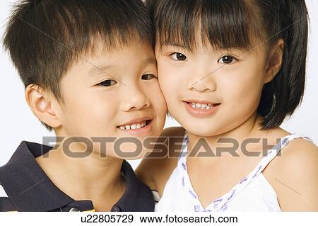 Stock Photo - Portrait of a girl and her brother. Fotosearch