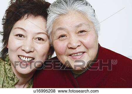 Stock Photo - Portrait of a mature woman and a senior woman smiling. Fotosearch