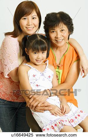 Stock Photography - Portrait of a mature woman with her daughter and her granddaughter. Fotosearch