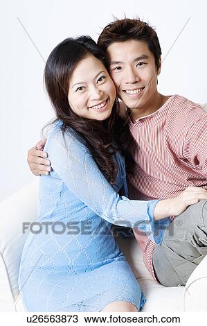 Stock Image - Portrait of a mid adult man and a young woman smiling. Fotosearch