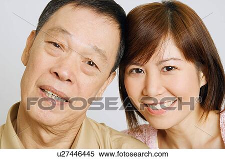 Stock Photography - Portrait of a senior man with his daughter smiling. Fotosearch