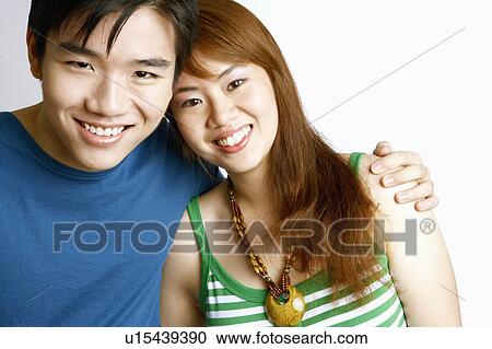 Portrait of a young couple posing and smiling View Large Photo Image Stock Image - Portrait of a young couple posing and smiling. Fotosearch