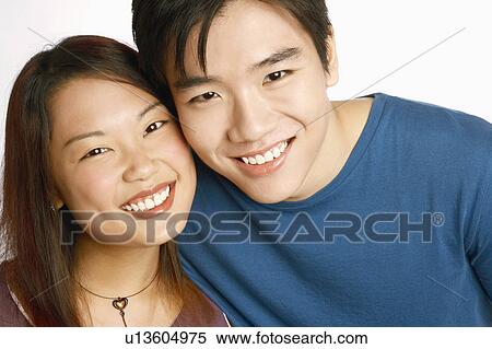 Portrait of a young couple posing and smiling View Large Photo Image Stock Photography - Portrait of a young couple posing and smiling. Fotosearch