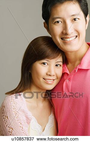 Stock Photo - Portrait of a young couple smiling. Fotosearch