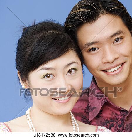 Stock Photo - Portrait of a young couple smiling. Fotosearch
