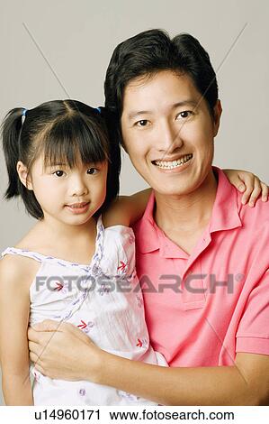 Portrait of a young man carrying his daughter View Large Photo Image Stock Image - Portrait of a young man carrying his daughter. Fotosearch