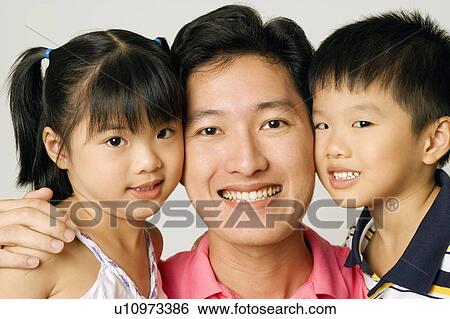 Portrait of a young man with his son and daughter View Large Photo Image Stock Photograph - Portrait of a young man with his son and daughter. Fotosearch