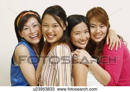 Portrait of four young women hugging each other and posing View Large Photo Image Stock Image - Portrait of four young women hugging each other and posing. Fotosearch