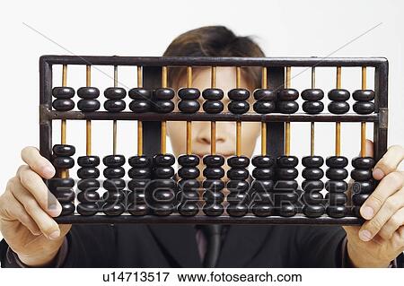 Stock Photo - Close-up of a businessman holding an abacus. Fotosearch
