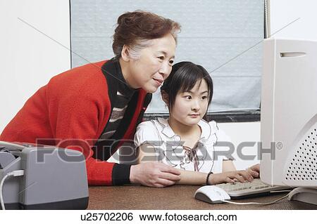 Close-up of a grandmother standing beside her granddaughter View Large Photo Image Stock Photograph - Close-up of a grandmother standing beside her granddaughter. Fotosearch