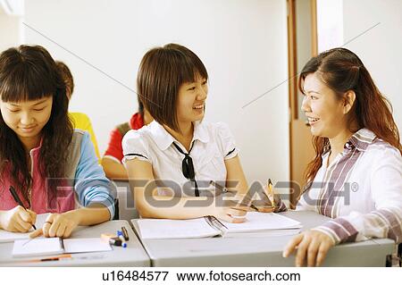 Close-up of a professor teaching her student in the classroom View Large Photo Image Stock Photo - Close-up of a professor teaching her student in the classroom. Fotosearch