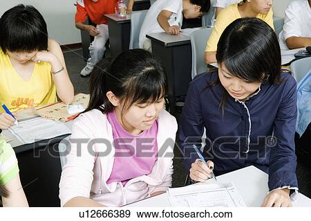 Stock Photo - Close-up of students in a classroom. Fotosearch