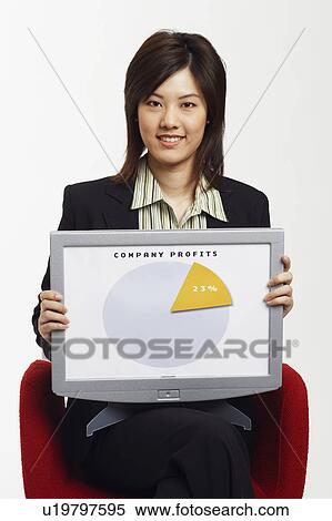 Stock Photography - Portrait of a businesswoman sitting on a chair and holding a progress report. Fotosearch