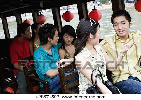 Three young couples traveling in a tourboat View Large Photo Image Stock Image - Three young couples traveling in a tourboat. Fotosearch