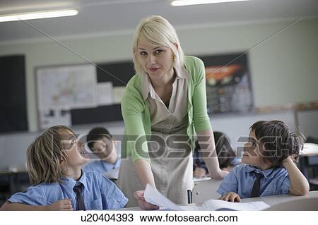 Female teacher explaining to students View Large Photo Image Stock Image - Female teacher explaining to students. Fotosearch