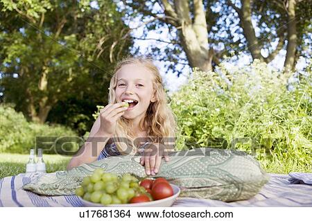 Girl eating grapes View Large Photo Image Picture - Girl eating grapes. Fotosearch