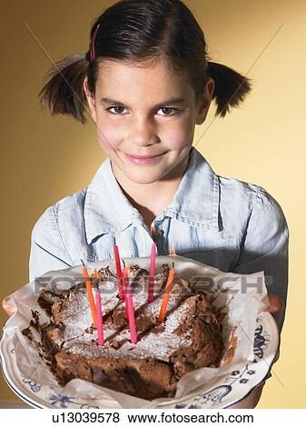 Girl holding a birthday cake View Large Photo Image Stock Photo - Girl holding a birthday cake. Fotosearch