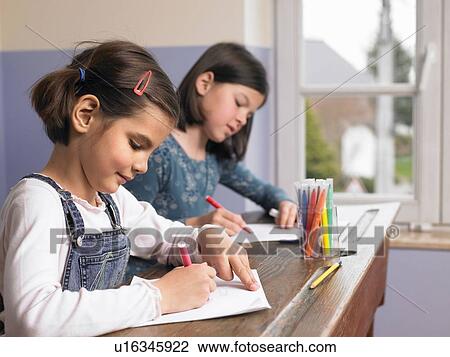 Stock Image - Girls drawing a picture. Fotosearch