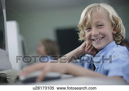 Stock Photography - School boy at computer. Fotosearch