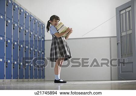 School girl holding stack of book View Large Photo Image Picture - School girl holding stack of book. Fotosearch