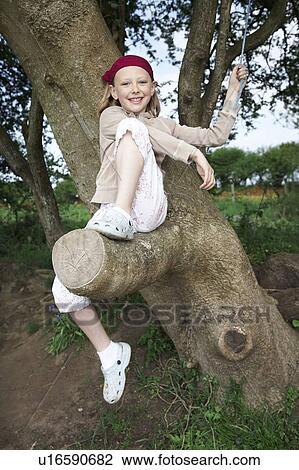 Young girl in tree View Large Photo Image Stock Image - Young girl in tree. Fotosearch