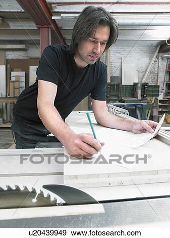 Carpenter working in his workshop. View Large Photo Image Stock Photo - Carpenter working in his workshop.. Fotosearch