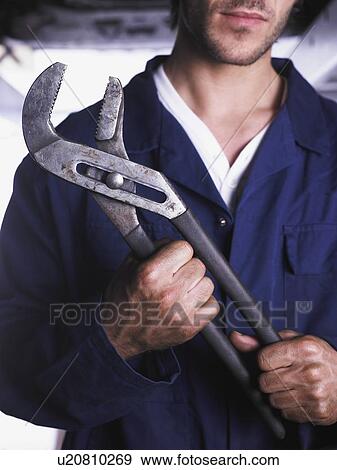 Close up of mechanic's hand holding wrench View Large Photo Image Stock Photo - Close up of mechanic's hand holding wrench. Fotosearch