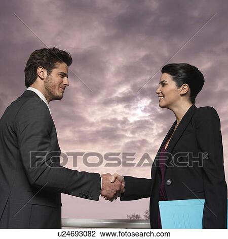 Couple outdoors, shaking hands View Large Photo Image Stock Image - Couple outdoors, shaking hands. Fotosearch