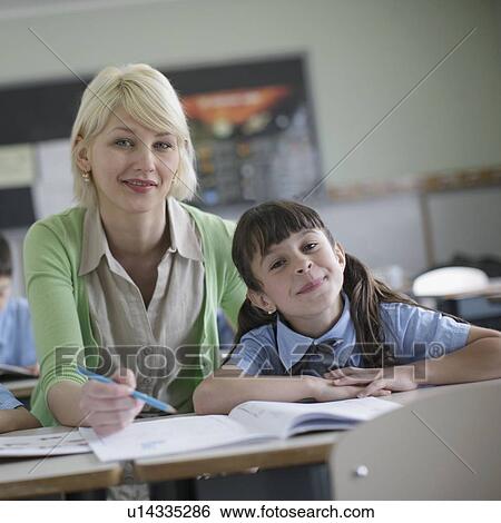 Female teacher explaining to student View Large Photo Image Stock Photograph - Female teacher explaining to student. Fotosearch