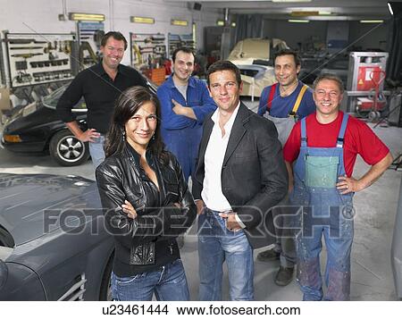 Picture - Group of workers and bosses in a garage.. Fotosearch