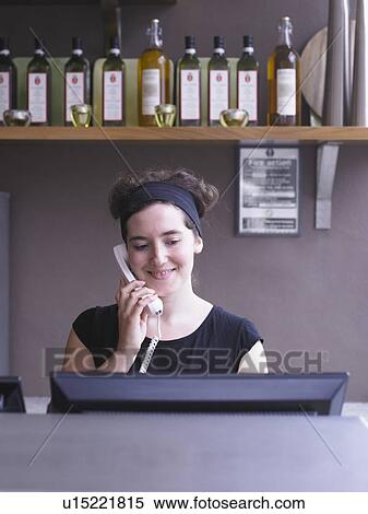 Hostess at her station in a restaurant View Large Photo Image Stock Photography - Hostess at her station in a restaurant. Fotosearch