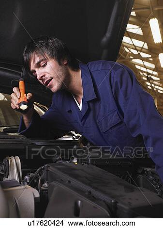 Picture - Mechanic working on an engine. Fotosearch