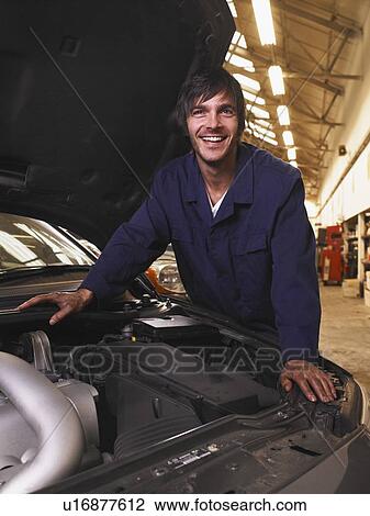 Stock Image - Mechanic working on an engine. Fotosearch