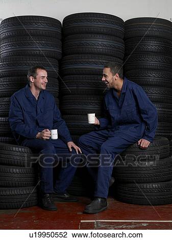 Stock Image - Mechanics on break drinking coffee. Fotosearch